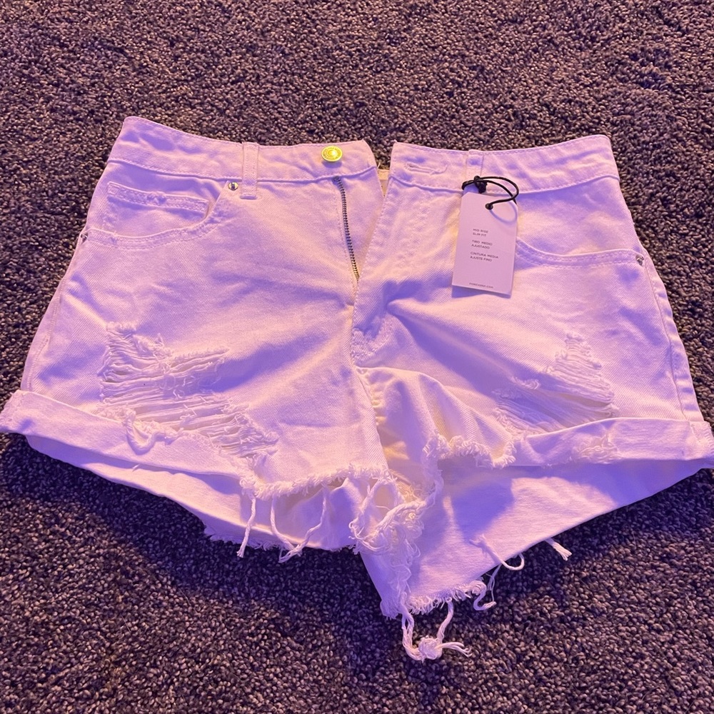 White ripped jean shorts